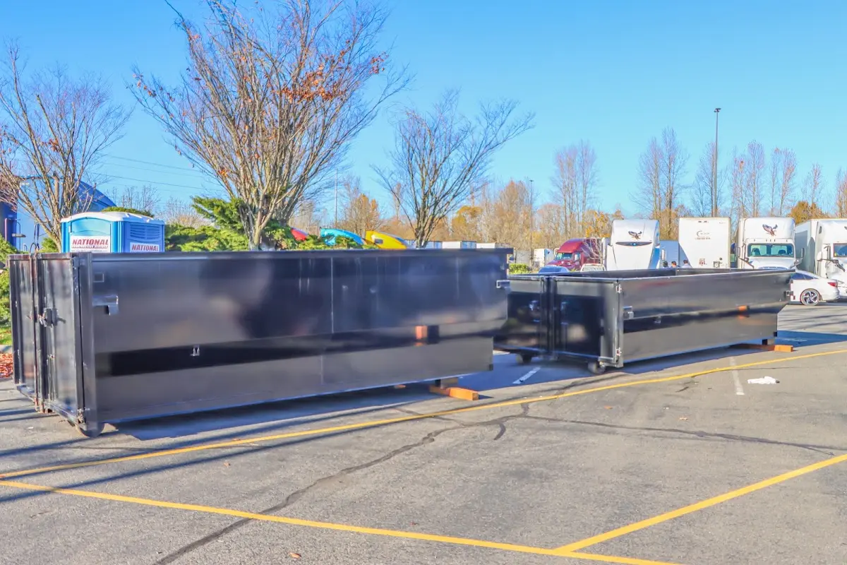 Professional dumpster rental service with roll-off container on residential driveway in Norton